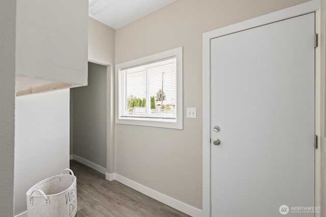 entryway with wood finished floors and baseboards