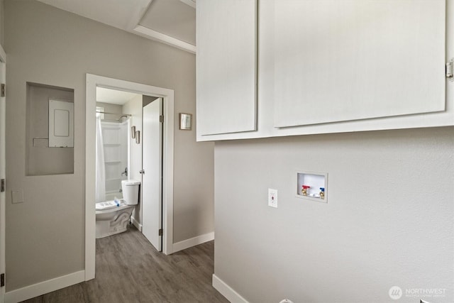 laundry room with wood finished floors, hookup for a washing machine, baseboards, and cabinet space