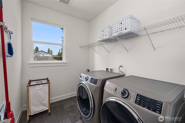 clothes washing area featuring washer and dryer, baseboards, and dark wood-style floors