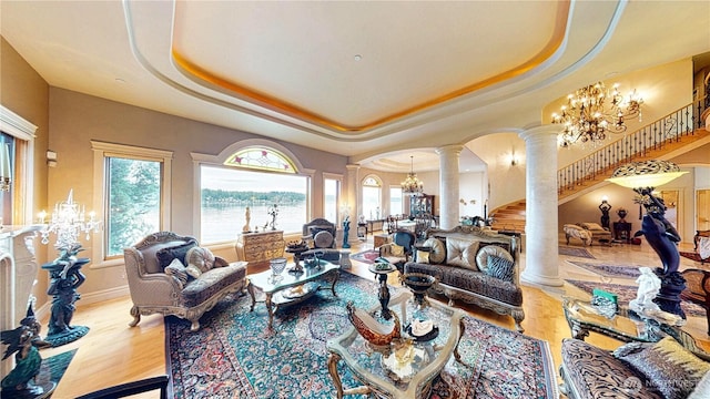 2837 E Lake Sammamish Pkwy NE, Sammamish, WA 98074 - living room featuring decorative columns, a chandelier, healthy amount of natural light, and a tray ceiling