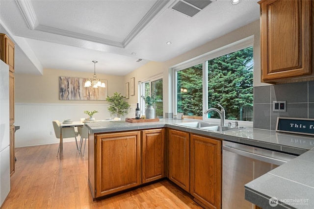 707 Harvest Rd, Bothell, WA 98012 - kitchen with dishwasher, a sink, brown cabinets, light wood-style flooring, and wainscoting
