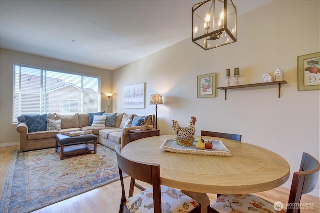 14721 1st Ln NE Unit 102, Duvall, WA 98019 - dining space featuring a chandelier and light wood-style flooring