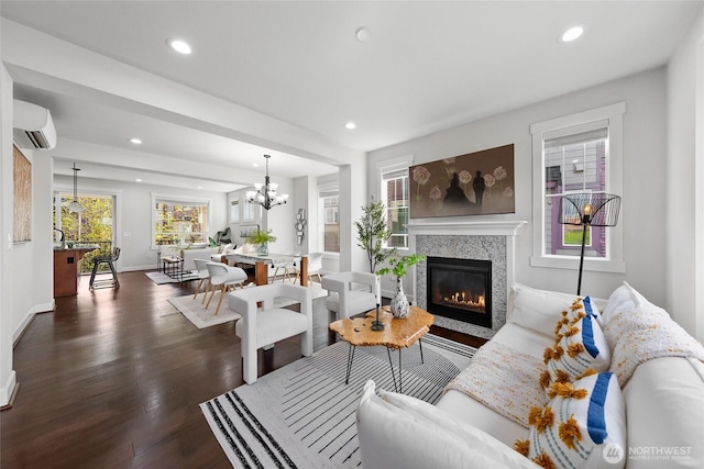 living room with a wall mounted AC, baseboards, dark wood-style floors, and recessed lighting