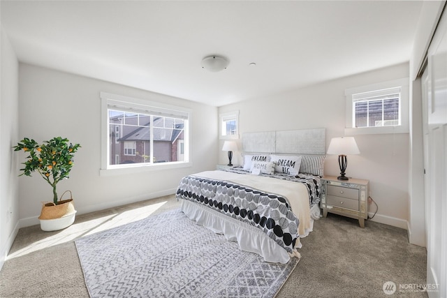 bedroom featuring carpet and baseboards