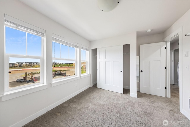 unfurnished bedroom with a closet, baseboards, and carpet floors