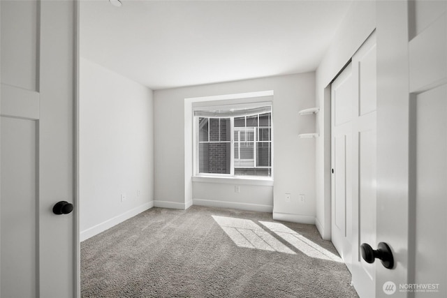 unfurnished bedroom featuring carpet flooring and baseboards