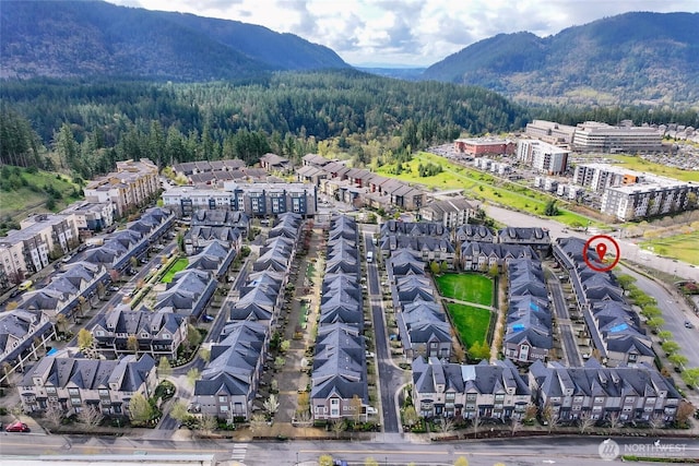 bird's eye view featuring a forest view and a mountain view