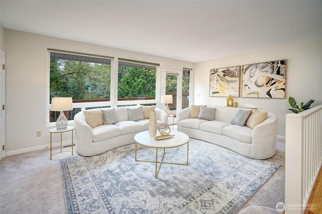 carpeted living area with baseboards and plenty of natural light