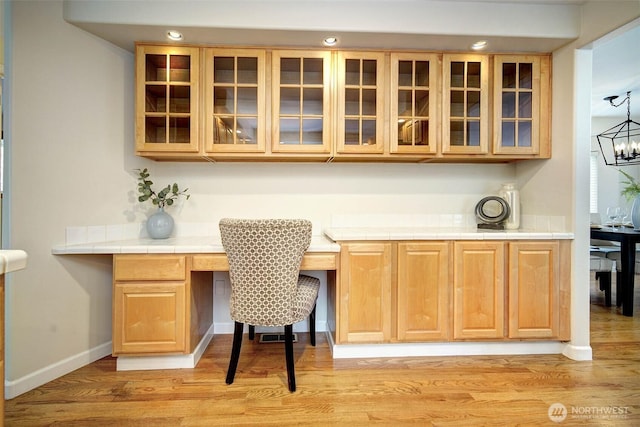 bar featuring recessed lighting, baseboards, built in study area, a chandelier, and light wood-type flooring