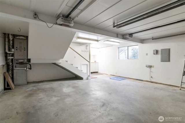 garage with electric panel and a garage door opener