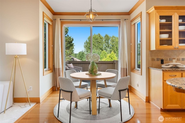 11758 175th Pl NE, Redmond, WA 98052 - dining area with light wood-style floors, baseboards, and crown molding