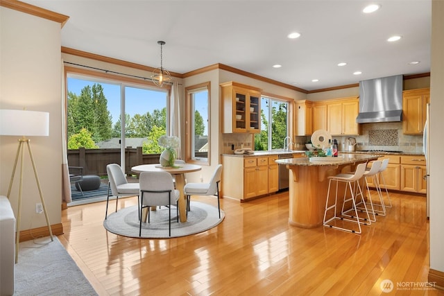 11758 175th Pl NE, Redmond, WA 98052 - kitchen with wall chimney exhaust hood, stainless steel appliances, crown molding, a kitchen breakfast bar, and recessed lighting