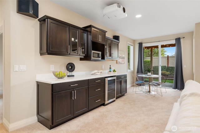 11758 175th Pl NE, Redmond, WA 98052 - kitchen with beverage cooler, light countertops, dark brown cabinetry, baseboards, and light carpet