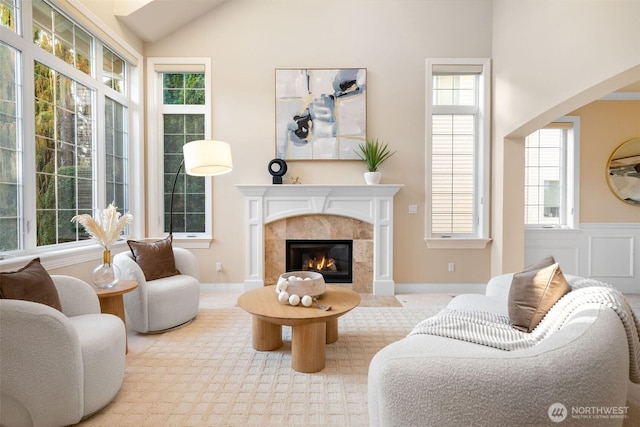 11758 175th Pl NE, Redmond, WA 98052 - living room featuring a tiled fireplace, vaulted ceiling, plenty of natural light, and arched walkways