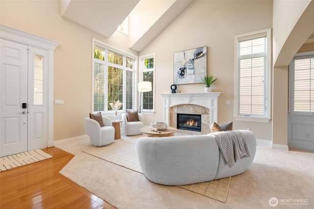 11758 175th Pl NE, Redmond, WA 98052 - living area with a fireplace, baseboards, high vaulted ceiling, and wood finished floors
