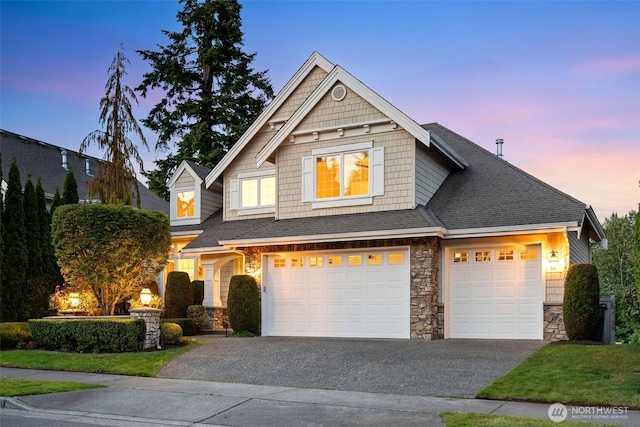 11758 175th Pl NE, Redmond, WA 98052 - view of front of house with asphalt driveway, stone siding, an attached garage, and a shingled roof