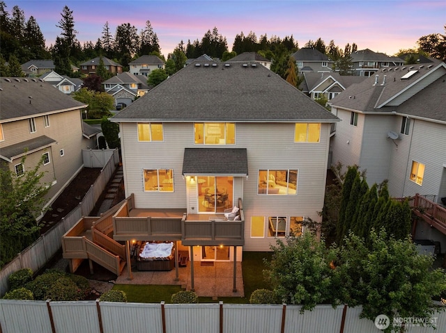 11758 175th Pl NE, Redmond, WA 98052 - back of house at dusk with a fenced backyard and a residential view
