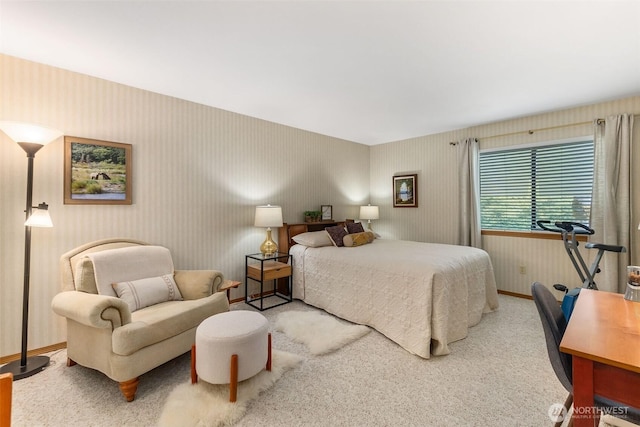 carpeted bedroom featuring wallpapered walls and baseboards