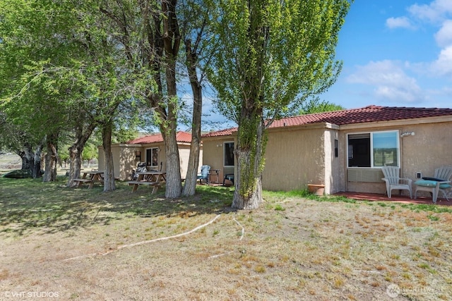 21058 State Highway 17 N, Soap Lake, WA 98851 - back of property with stucco siding, a tiled roof, and a yard
