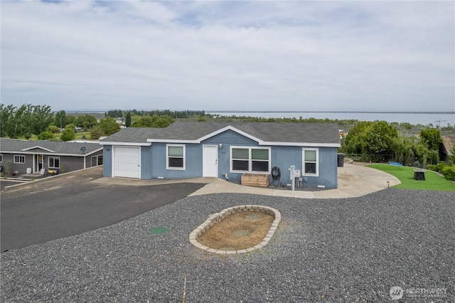 ranch-style home with driveway and a garage