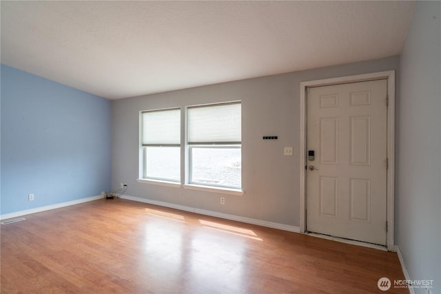 entrance foyer featuring wood finished floors and baseboards
