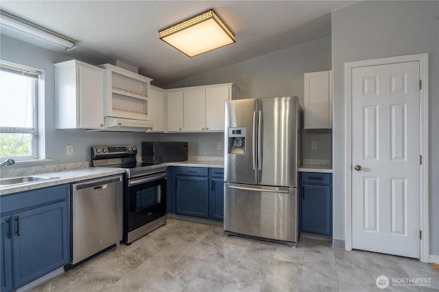 kitchen featuring appliances with stainless steel finishes, blue cabinets, a sink, under cabinet range hood, and white cabinetry