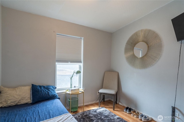 bedroom featuring wood finished floors and baseboards