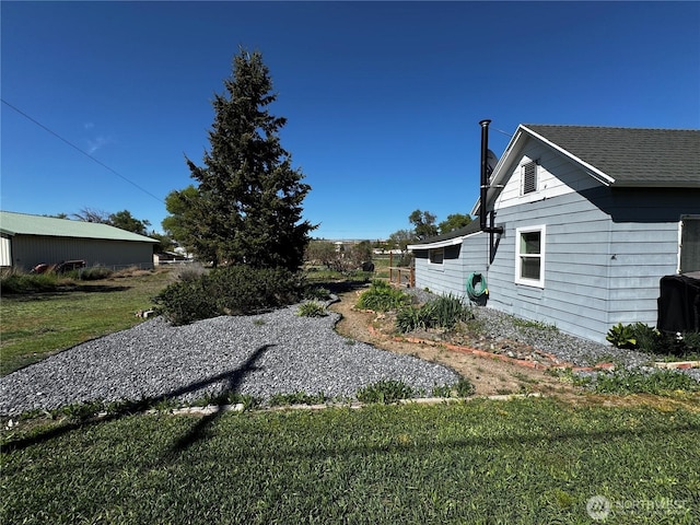 view of side of home featuring a yard