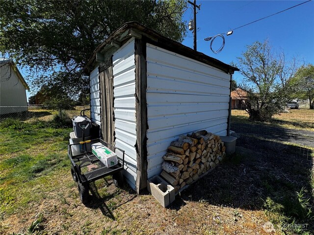 view of shed featuring fence