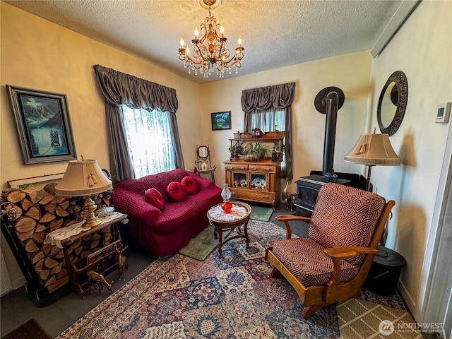 living area featuring a wood stove, an inviting chandelier, and a textured ceiling