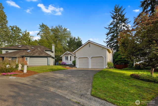 view of front of property with driveway, a front yard, and a garage