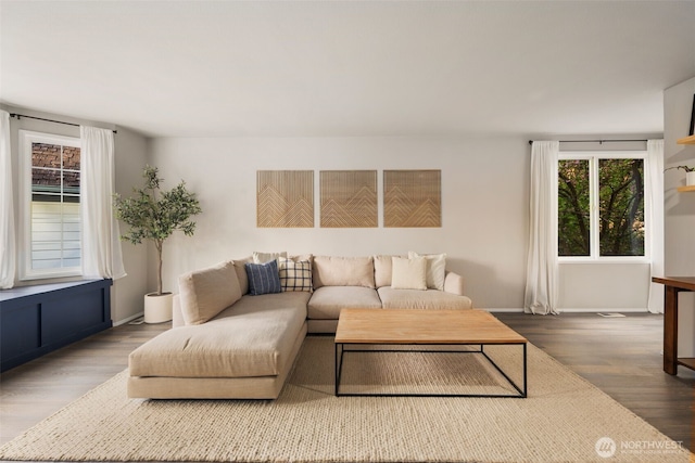 living room featuring wood finished floors and baseboards