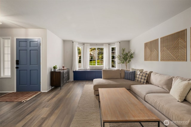 living room featuring wood finished floors and baseboards