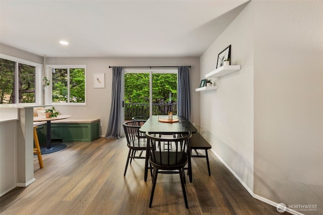 dining space with wood finished floors, baseboards, breakfast area, and recessed lighting