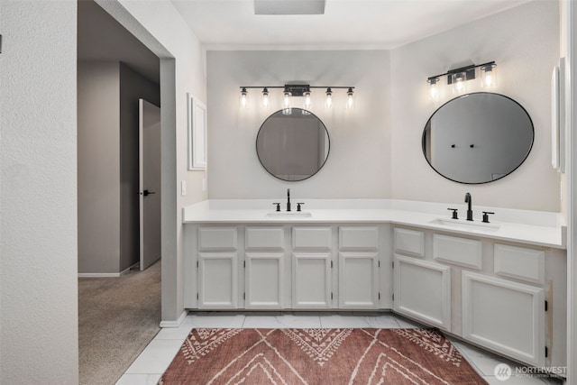 full bath with tile patterned floors, double vanity, and baseboards
