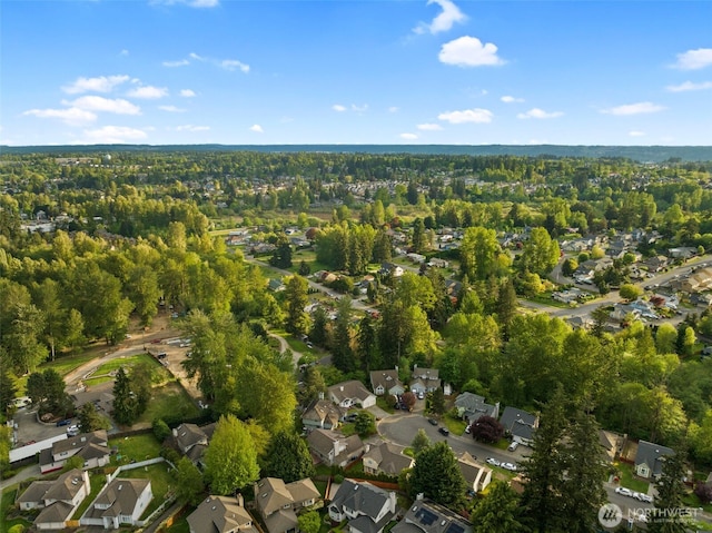 aerial view of property and surrounding area featuring nearby suburban area