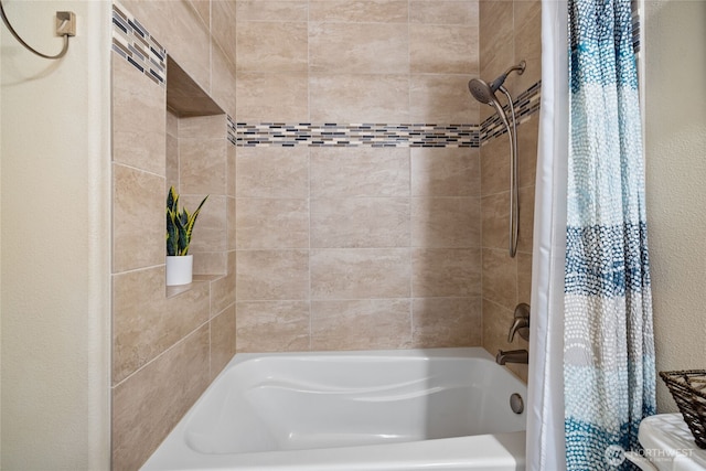 full bathroom with shower / bathtub combination with curtain and a textured wall