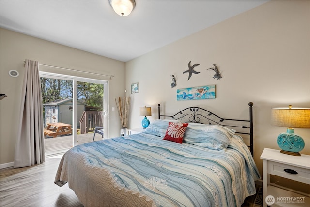 bedroom with access to exterior, wood finished floors, and baseboards