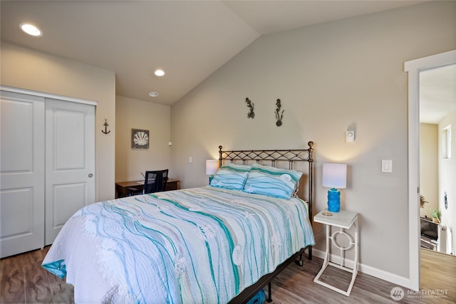 bedroom featuring vaulted ceiling, wood finished floors, a closet, baseboards, and recessed lighting