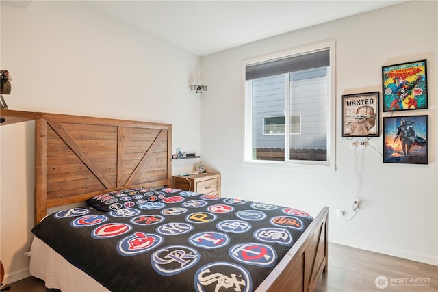 bedroom featuring light wood-style floors and baseboards