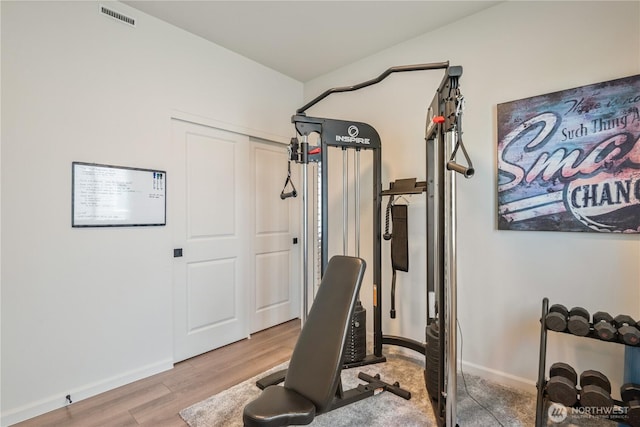 workout room with wood finished floors and baseboards