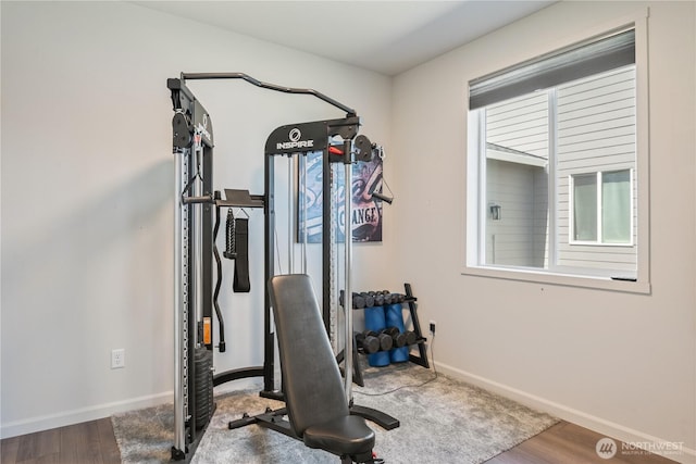 workout area with wood finished floors and baseboards