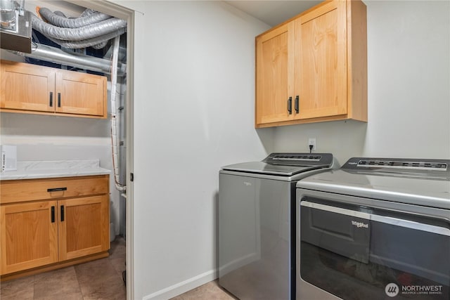 washroom with cabinet space and separate washer and dryer