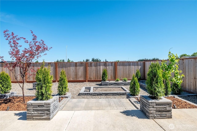 view of patio / terrace featuring a garden and a fenced backyard