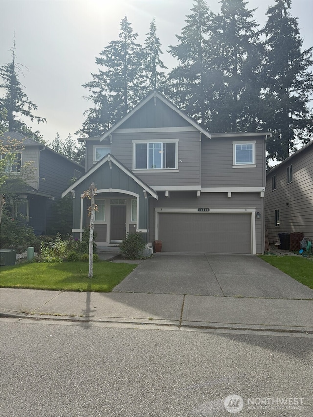 17510 80th Avenue Ct E, Puyallup, WA 98375 - view of front of home with board and batten siding, an attached garage, driveway, and a front yard
