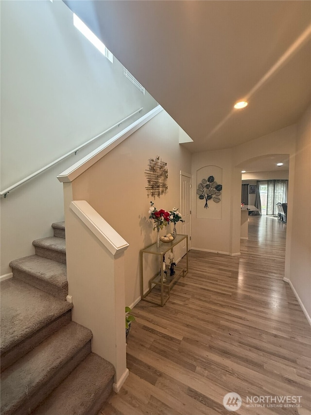 17510 80th Avenue Ct E, Puyallup, WA 98375 - corridor with baseboards, stairs, arched walkways, and wood finished floors