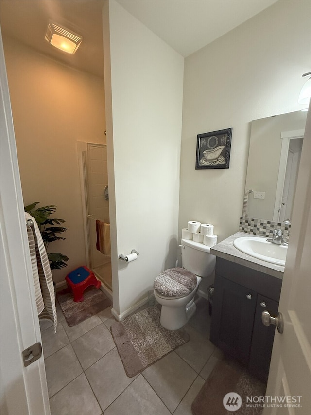 17510 80th Avenue Ct E, Puyallup, WA 98375 - full bath featuring toilet, a stall shower, tile patterned floors, backsplash, and vanity