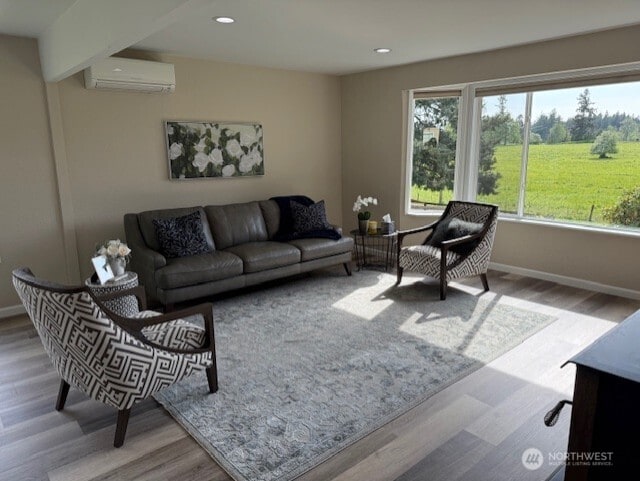 39418 200th Ave SE, Auburn, WA 98092 - living room featuring an AC wall unit, wood finished floors, baseboards, and recessed lighting