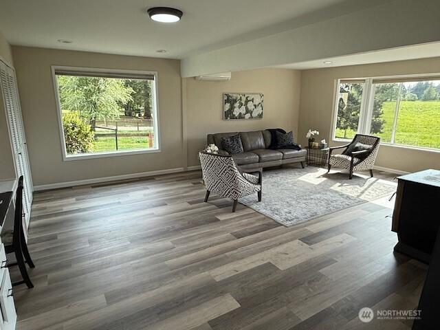 39418 200th Ave SE, Auburn, WA 98092 - living room featuring healthy amount of natural light, baseboards, and wood finished floors