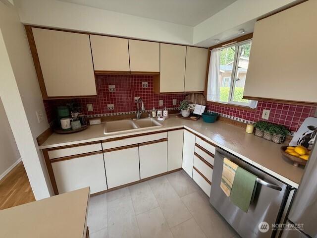 39418 200th Ave SE, Auburn, WA 98092 - kitchen featuring a sink, backsplash, light countertops, and stainless steel dishwasher